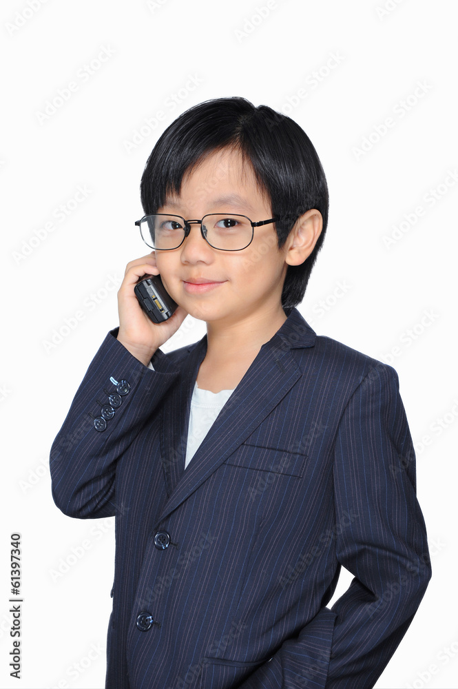 Cute Asian boy in suit making phone call Cute Asian boy in suit making phone call