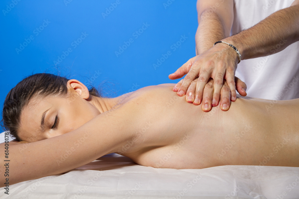 Relaxation. Masseur doing massage on woman body in the spa salon Relaxation. Masseur doing massage on woman body in the spa salon