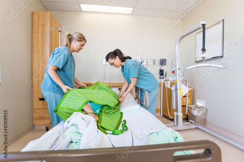 Nurses Preparing Patient Before Transferring Him On Hydraulic Li