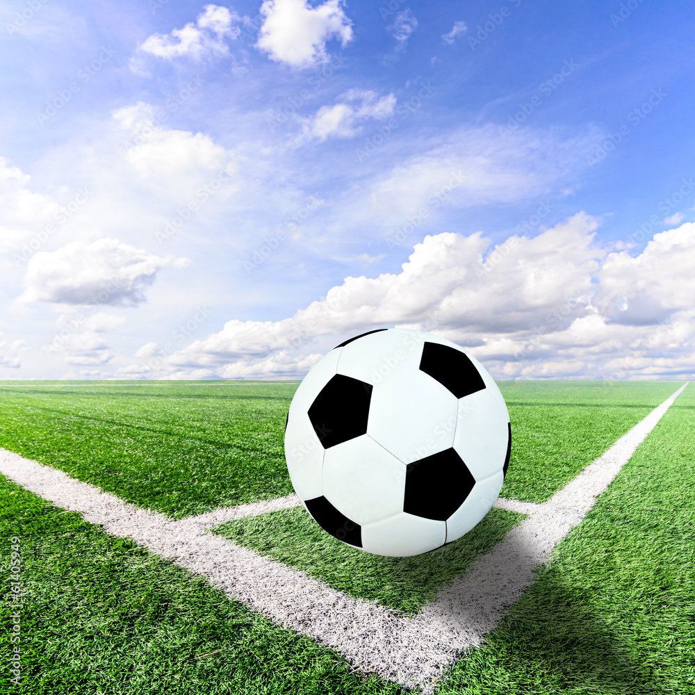Fototapeta premium Ball on Corner of a soccer field and blue sky