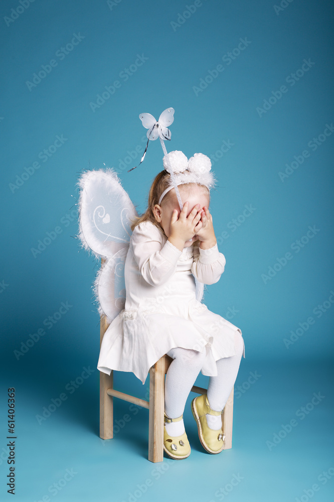 Cute little girl with butterfly costume on blue background Cute little girl with butterfly costume on blue background
