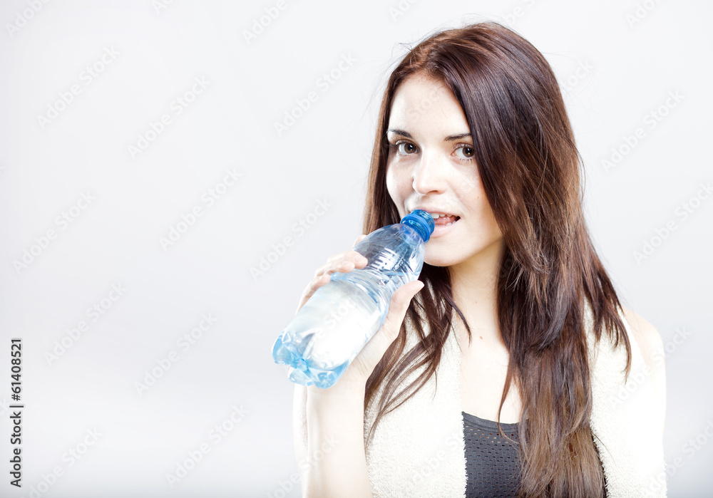 Young fit woman drinking water after fitness Young fit woman drinking water after fitness