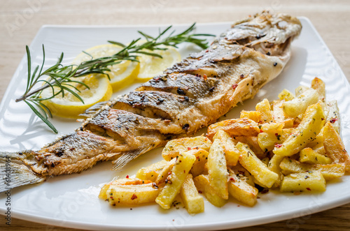 Baked seabass with fried potatoes photo