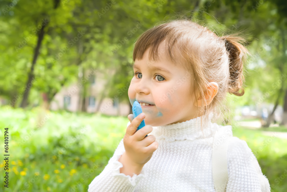 Cute little hellion girl with blue chalk outdoors Cute little hellion girl with blue chalk outdoors