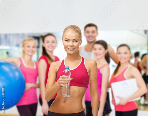 smiling woman with bottle of water