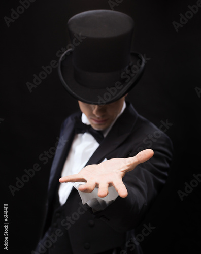 magician holding something on palm of his hand photo