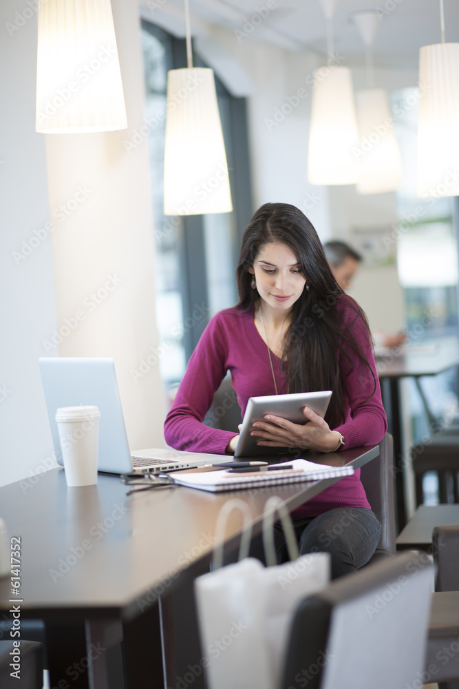 handsome woman using digital tablet in a cafe handsome woman using digital tablet in a cafe