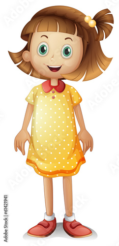 A cute young girl wearing a yellow polka dress