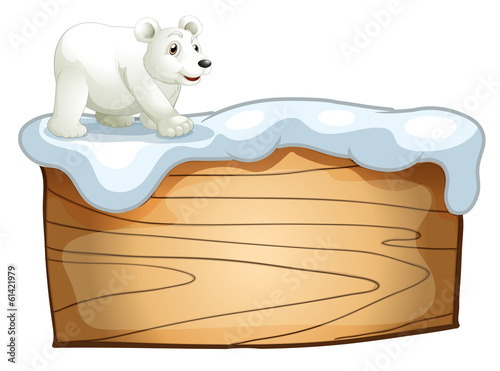 A polar bear above the empty wooden signboard