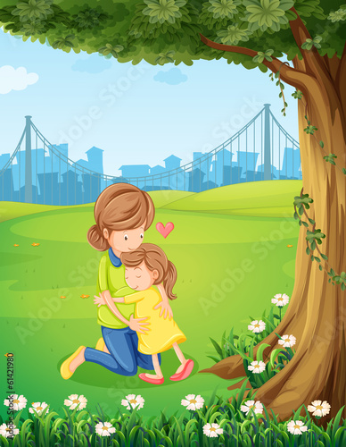 A mother hugging her daughter under the tree