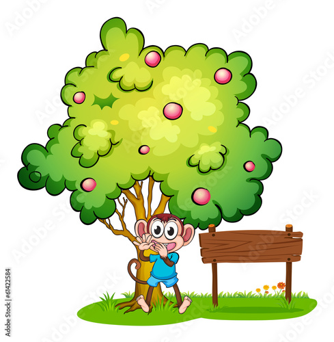 An empty signboard beside the monkey under the tree