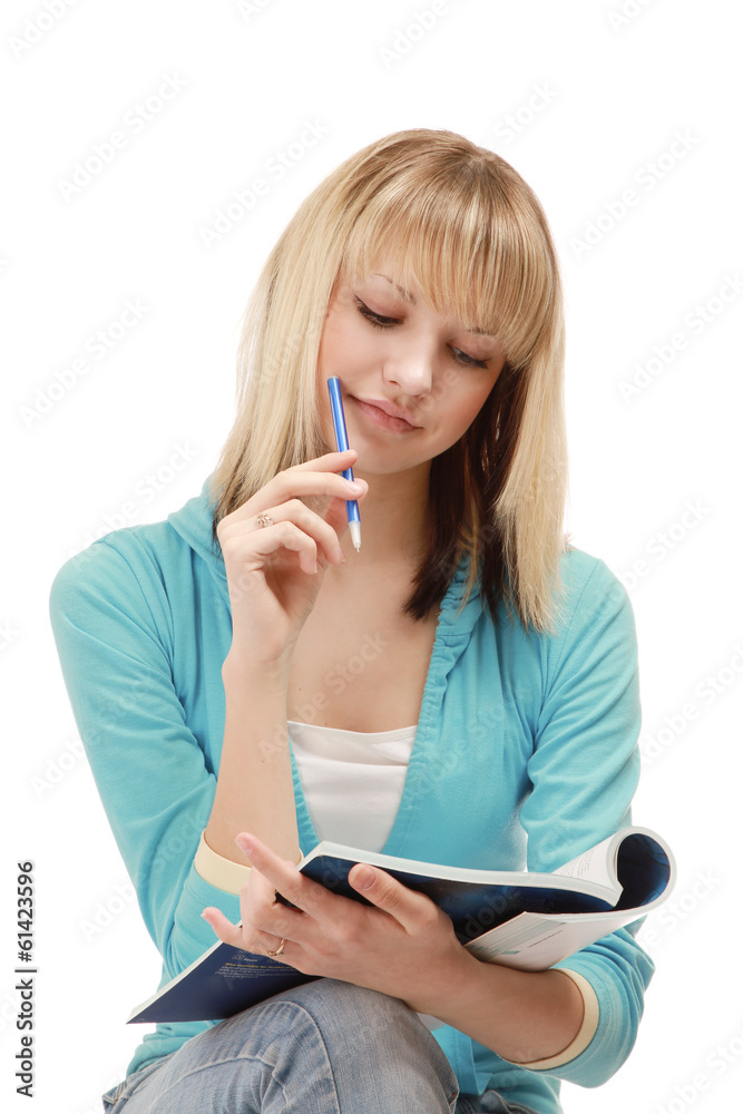 A pensive college girl with a pen and a textbook A pensive college girl with a pen and a textbook