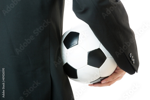 Fototapeta Naklejka Na Ścianę i Meble -  Back view of Businessman holding soccer ball