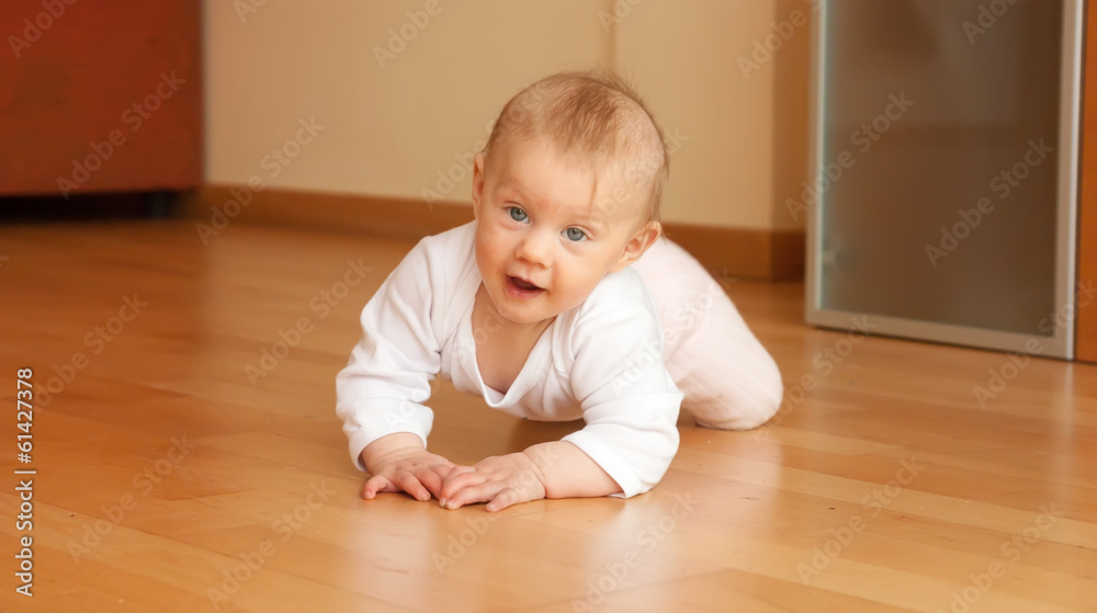 little girl  in pink lying on the floor.