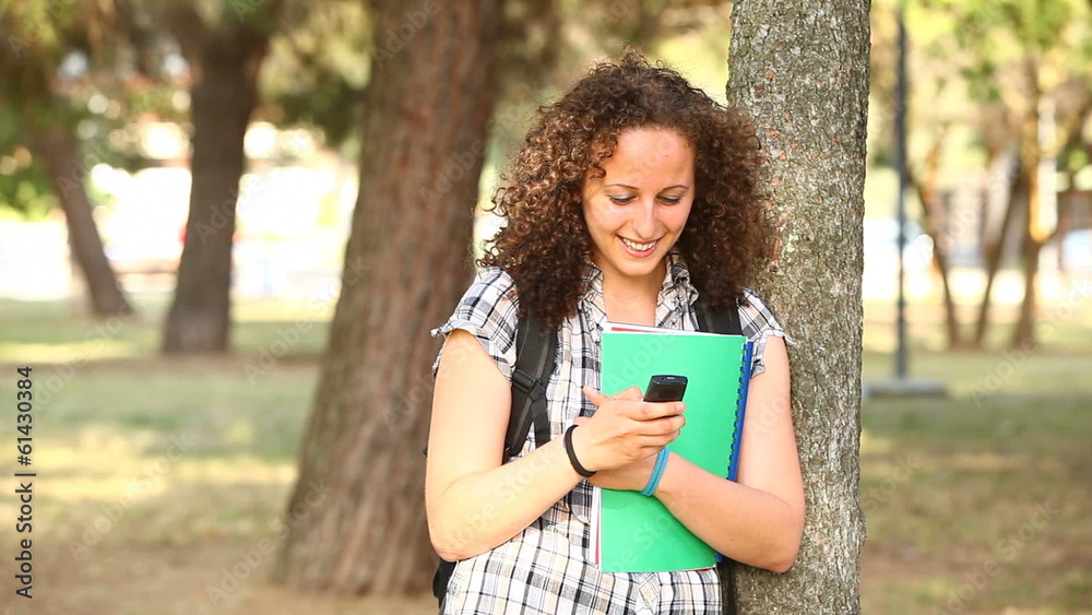 Beautiful Young Student with Mobile Phone at Park Beautiful Young Student with Mobile Phone at Park