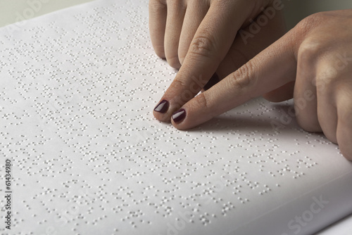 Blind reading text in braille language photo