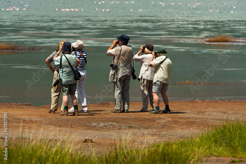 Photography Group of seniors on photo safari in Africa observing animals