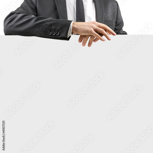 Businessman resting his hands on a blank sign