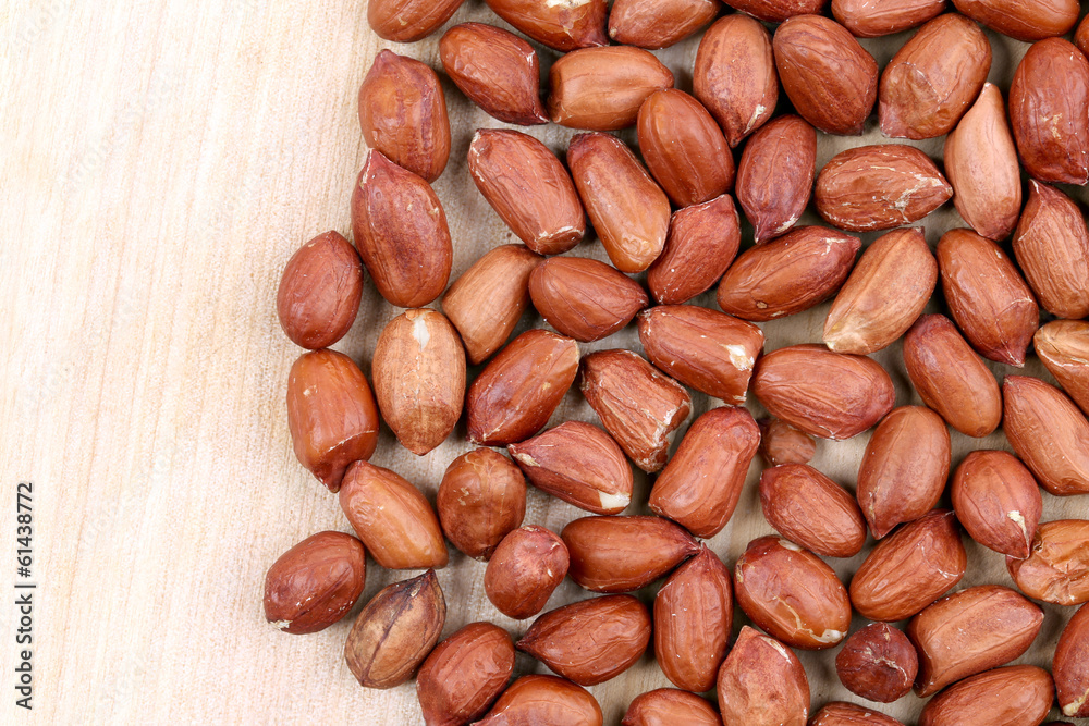 Close up of peanuts. Wooden plate. Close up of peanuts. Wooden plate.
