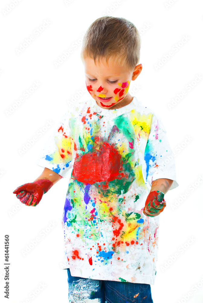 Smiling boy paints paints