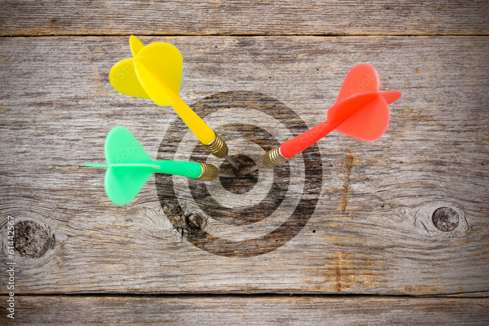 Darts hitting target on a wooden planks Darts hitting target on a wooden planks