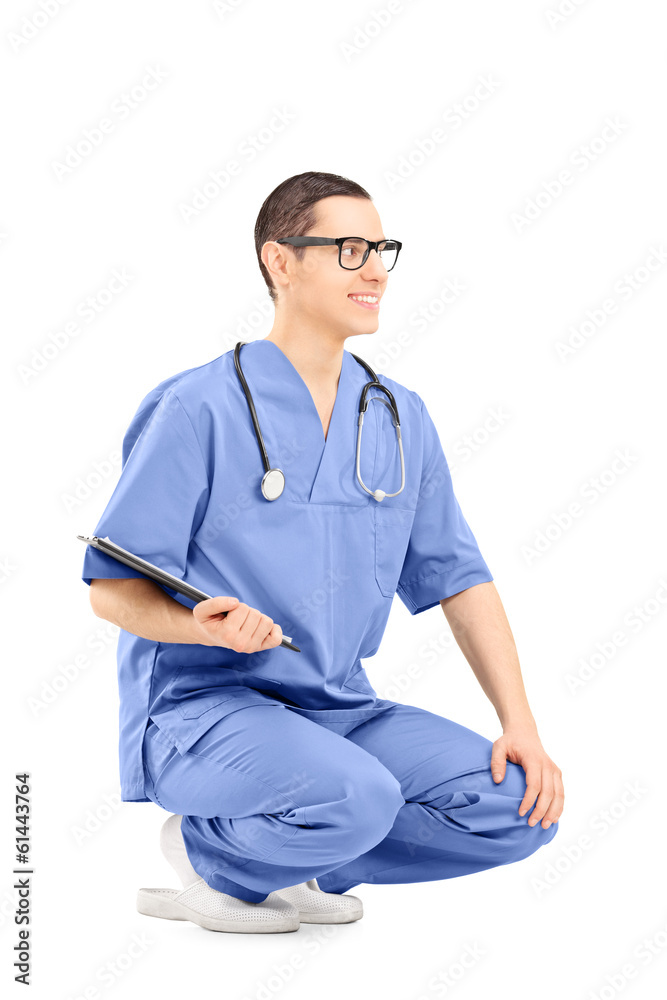 Male medical worker crouching and holding clipboard Male medical worker crouching and holding clipboard