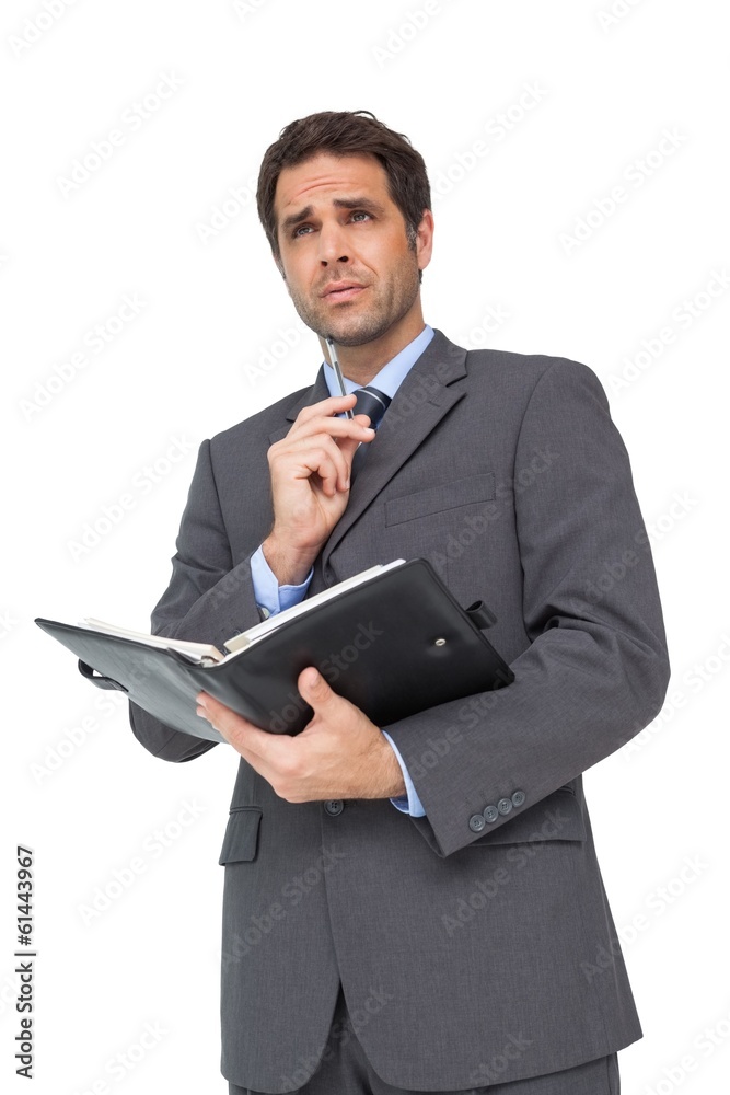 Handsome businessman holding his diary Handsome businessman holding his diary