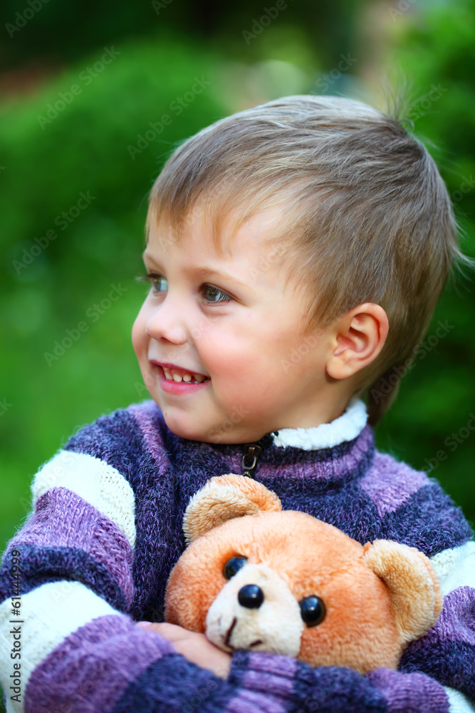 Smiling boy with a soft toy teddy bear Smiling boy with a soft toy teddy bear