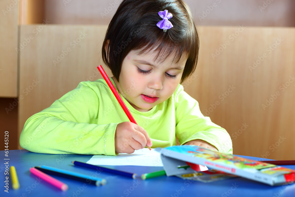 A girl draws with crayons A girl draws with crayons
