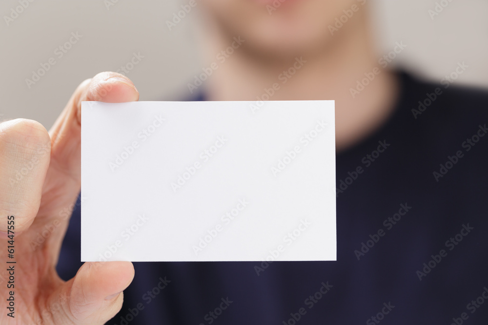 adult man hand holding empty business card in front of camera adult man hand holding empty business card in front of camera