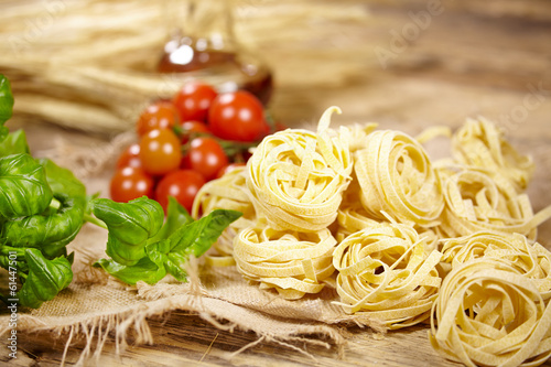 Italian food background, with vine tomatoes, basil, spaghetti