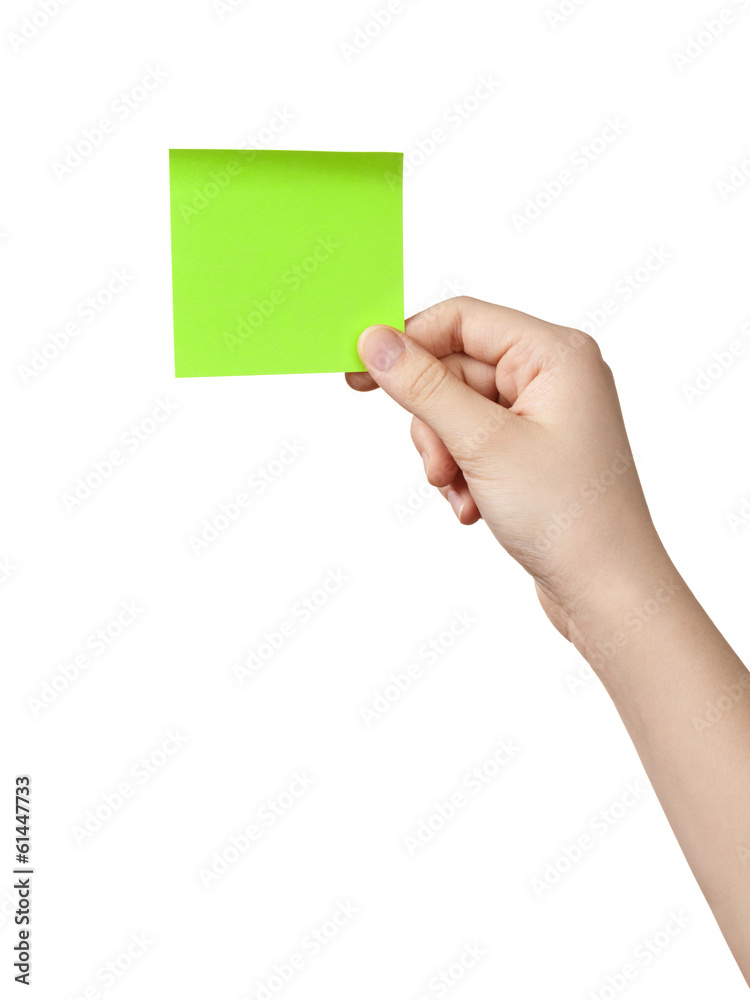 female teen hand holding green sticky note female teen hand holding green sticky note