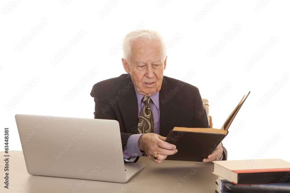Elderly man business computer look at book Elderly man business computer look at book