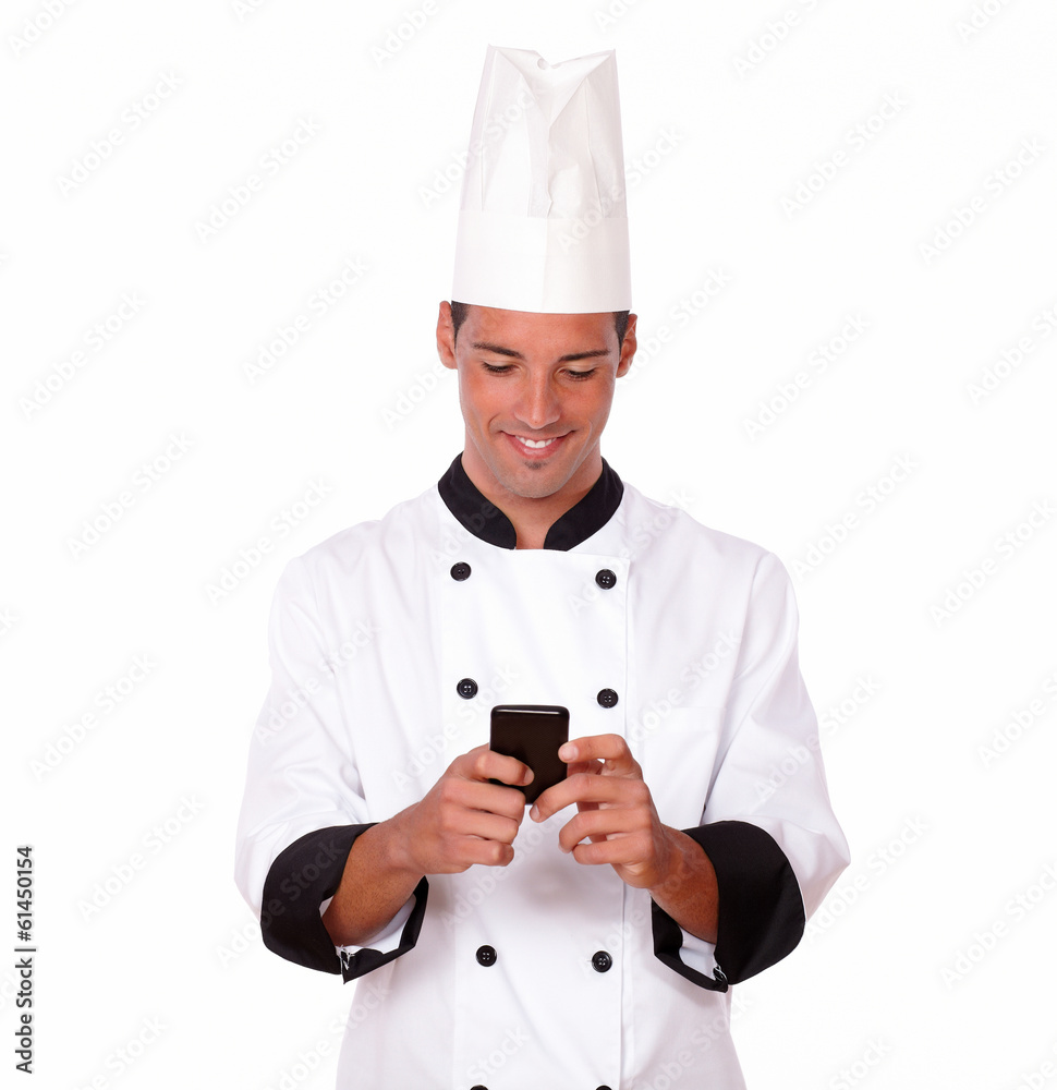 Professional young chef texting a message Professional young chef texting a message
