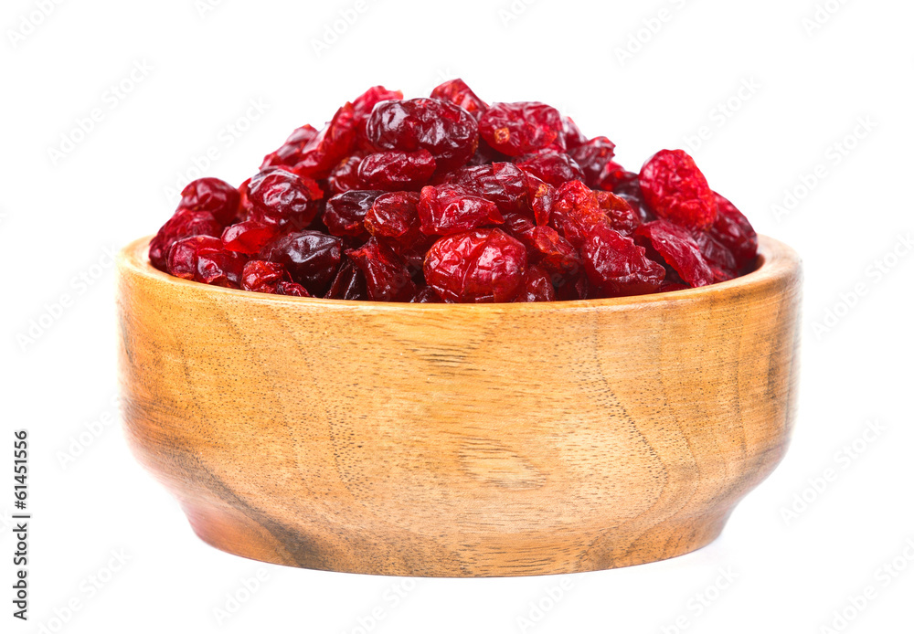 A bowl of dried cranberries on a white background A bowl of dried cranberries on a white background