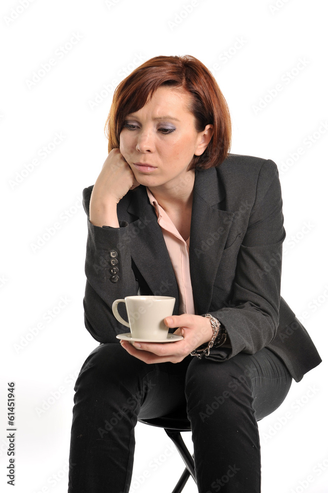 sad business woman with red hair drinking coffee and thinking sad business woman with red hair drinking coffee and thinking