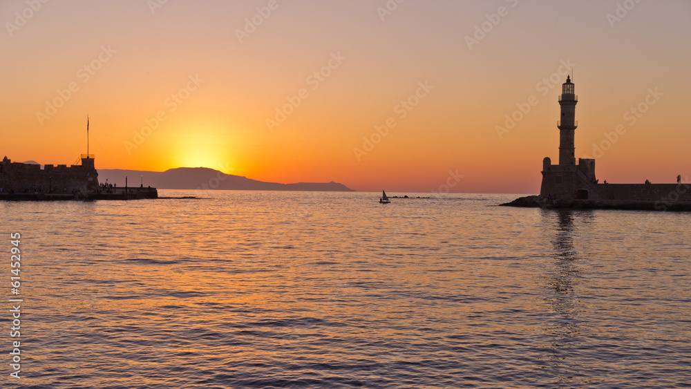 Panoramic view of Chania harbor with lighthouse at sunset, Crete