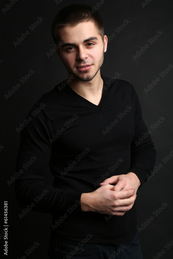 Handsome young man on dark background