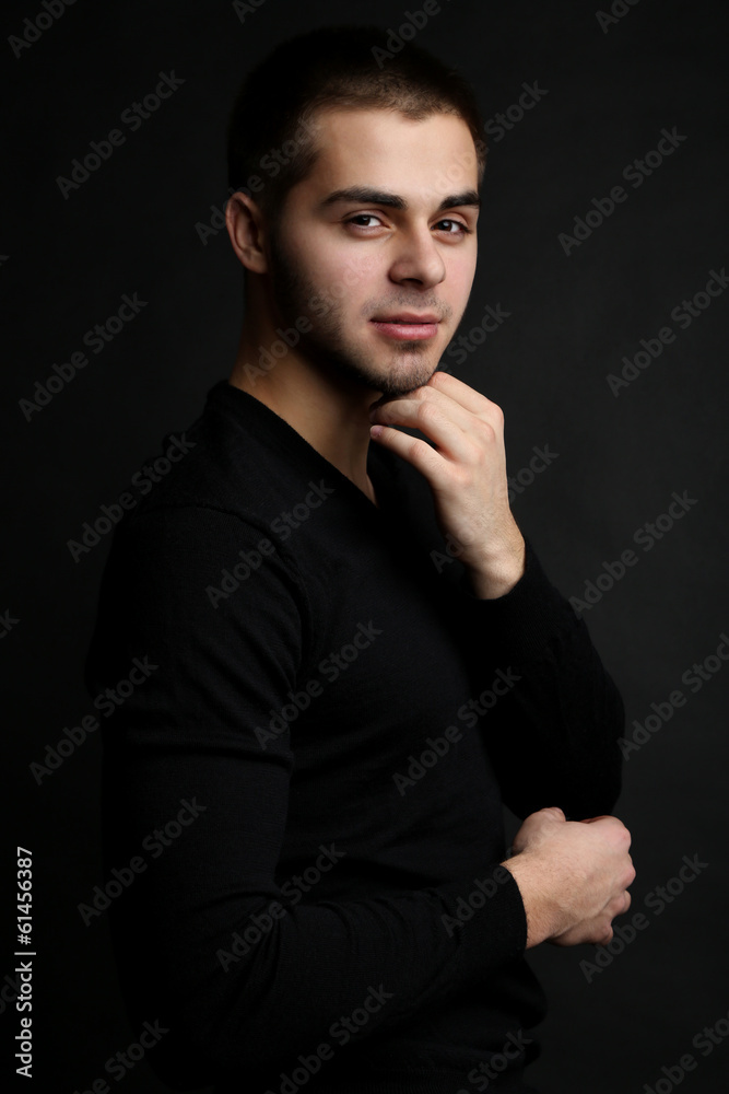 Handsome young man on dark background