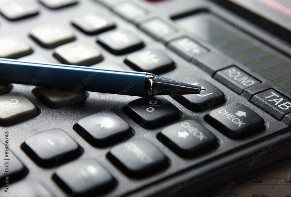 Closeup image of calculator keyboard and pen Closeup image of calculator keyboard and pen