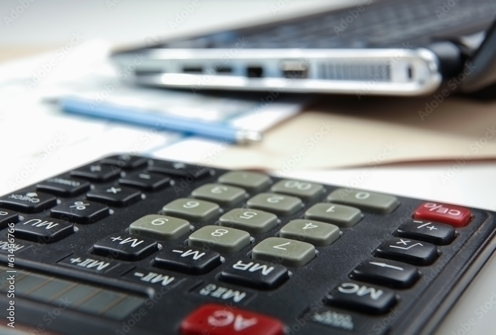 Calculator, pen, folder with documents, laptop. Calculator, pen, folder with documents, laptop.