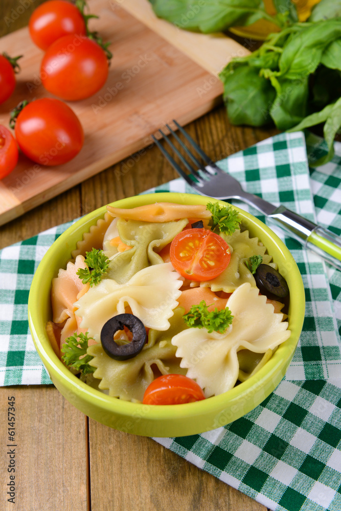 Delicious pasta with tomatoes on plate on table close-up Delicious pasta with tomatoes on plate on table close-up