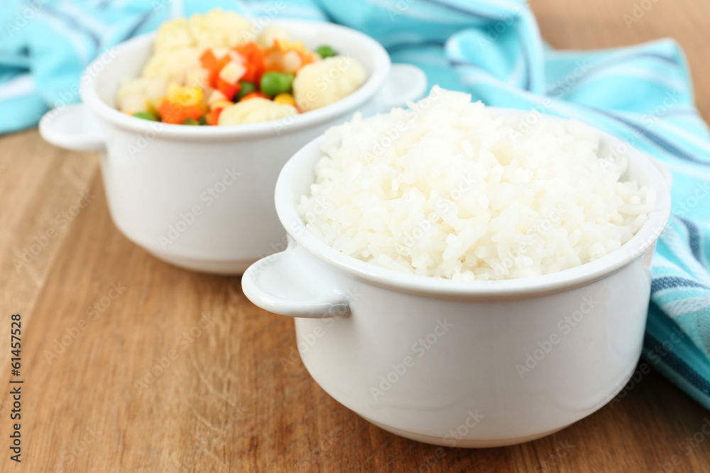 Cooked rice with vegetables on wooden table close up Cooked rice with vegetables on wooden table close up