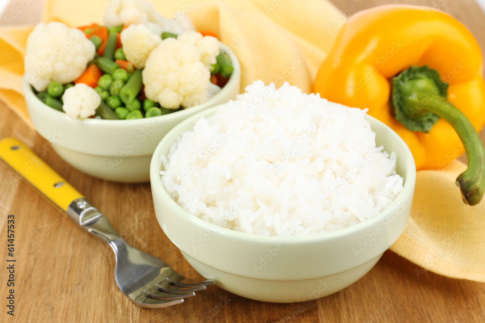 Cooked rice with vegetables on wooden table close up Cooked rice with vegetables on wooden table close up