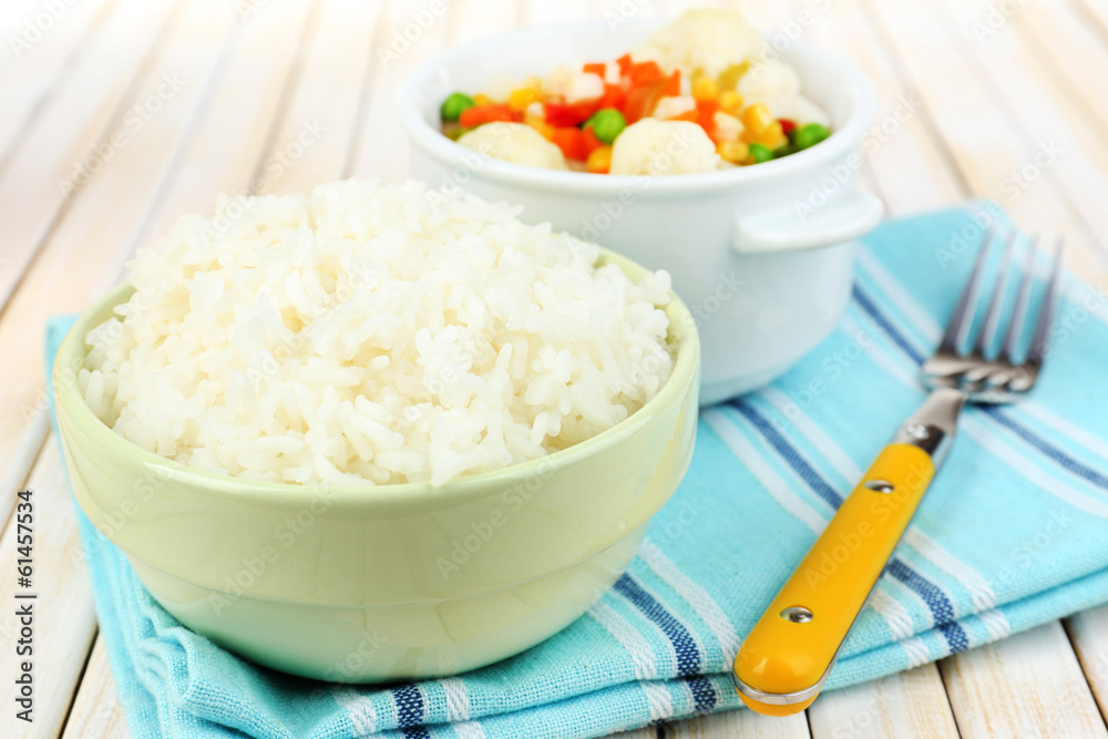 Cooked rice with vegetables on wooden table close up Cooked rice with vegetables on wooden table close up