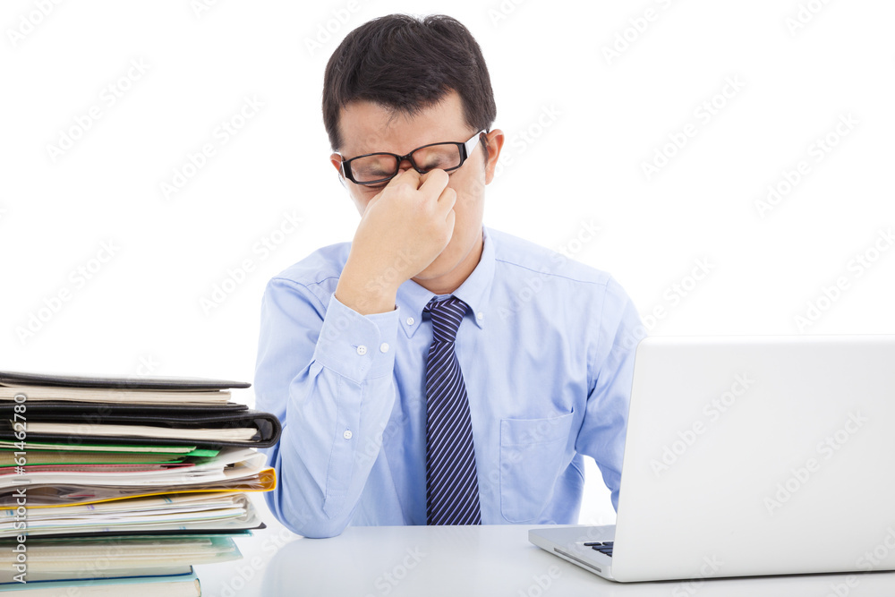businessman is too overwork to rubbing his eyes businessman is too overwork to rubbing his eyes