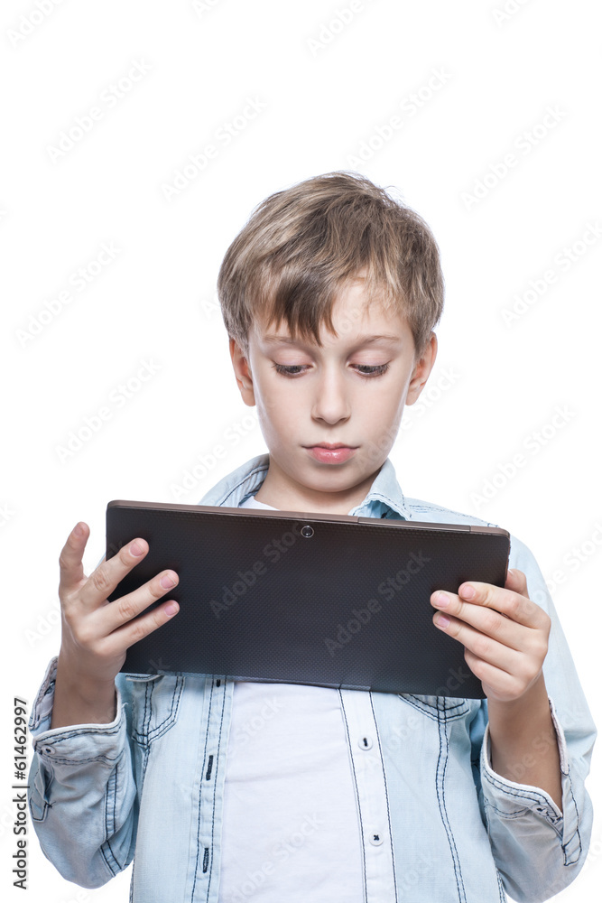 Cute child in blue shirt holding a tablet PC smiling Cute child in blue shirt holding a tablet PC smiling