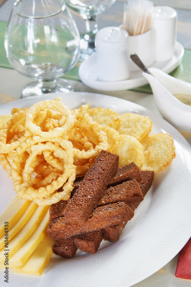 Fried croutons on a plate with sauce on a served table