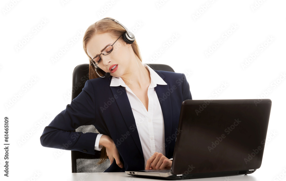 Young attractive business woman at call center is having backach Young attractive business woman at call center is having backach