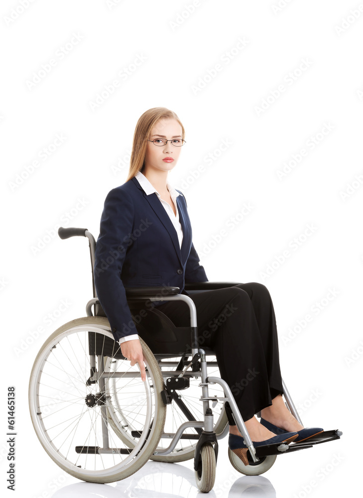 Sad, serious business woman sitting on wheelchair. Sad, serious business woman sitting on wheelchair.